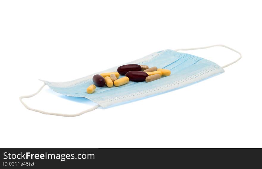 Medicines on a medical mask it is isolated on a white background. Medicines on a medical mask it is isolated on a white background.