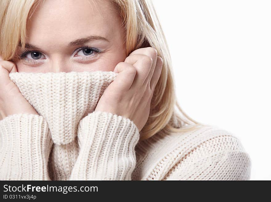 Attractive girl closes sweater face. Attractive girl closes sweater face