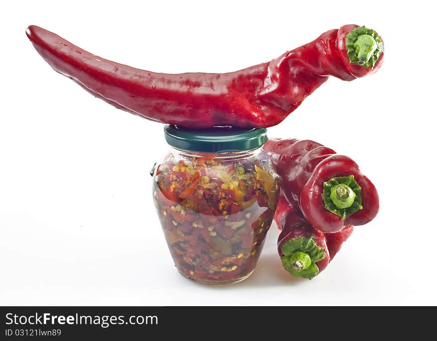 Sweet peppers and preserved on a white background. Sweet peppers and preserved on a white background