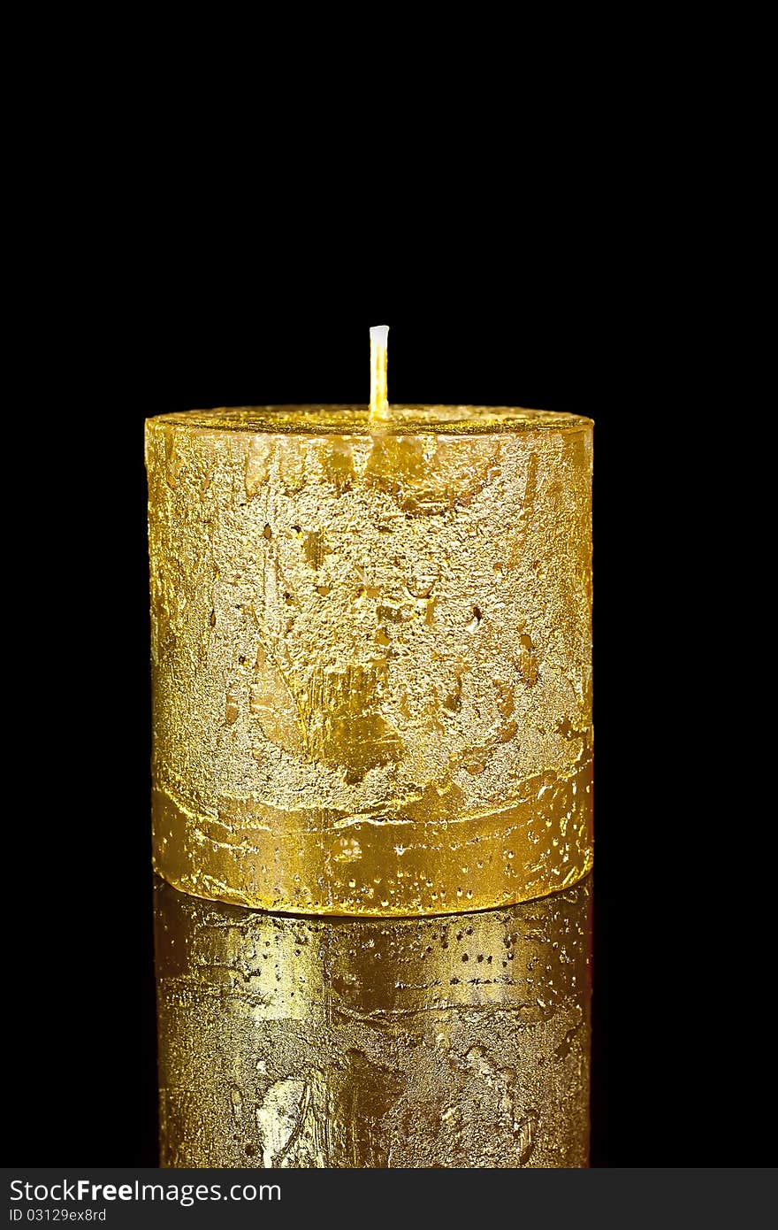 Candle gold on a black reflective background. Candle gold on a black reflective background.