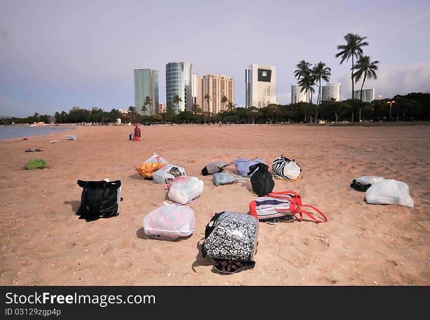 Many Bags On A Sandy Beach With Buildings