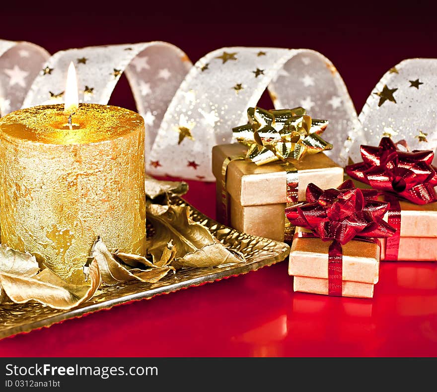 Christmas Decor, on a red background, candles, gift boxes and Bantu with the stars. Christmas Decor, on a red background, candles, gift boxes and Bantu with the stars.