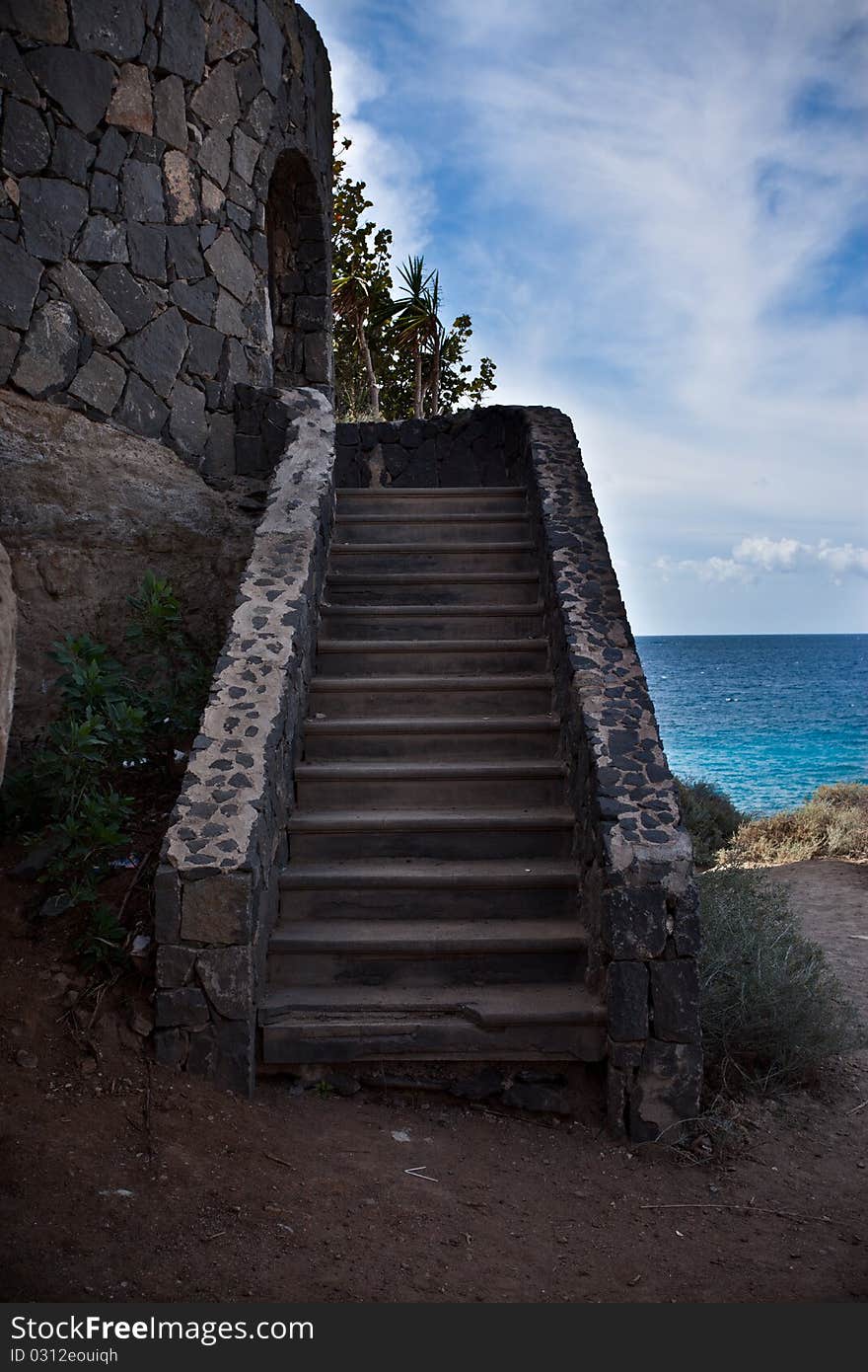 Small staircase leading to an old building at the beach