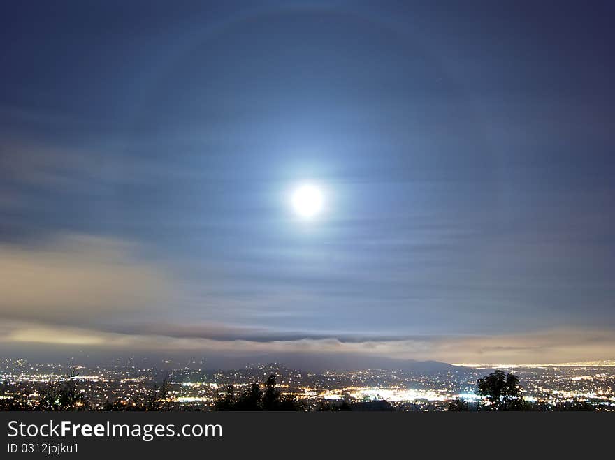 At the top of a mountain, in the middle of the night. A city, teeming with lights, is minuscule compared to the awesome size of the sky. At the top of a mountain, in the middle of the night. A city, teeming with lights, is minuscule compared to the awesome size of the sky.