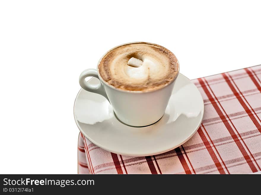 Coffee (cappuccino) with sugar on a corner of a table