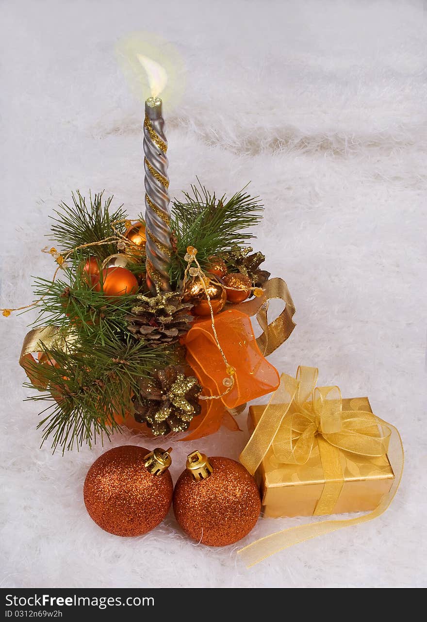 Christmas silver candles and golden box on the white skin