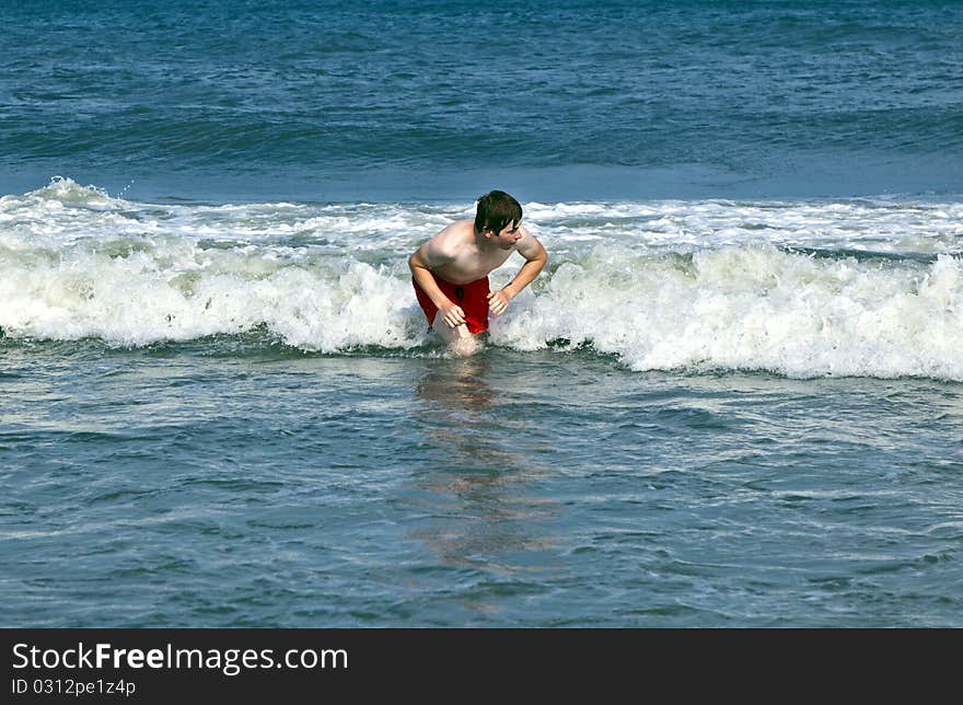 Young Boy Is Body Surfing In The Waves