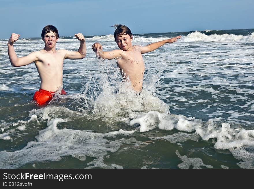 Boys have fun in the beautiful ocean with waves. Boys have fun in the beautiful ocean with waves