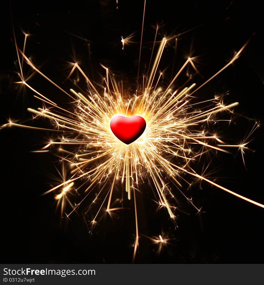 Burning sparkler in the shape of a heart. Burning sparkler in the shape of a heart