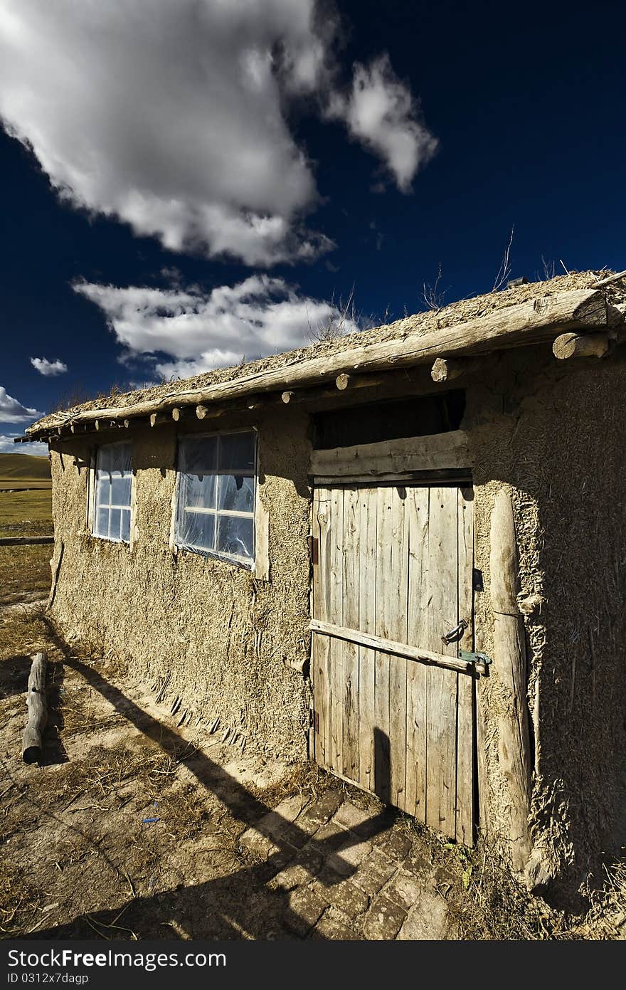 Autumn panorama with old wooden house.