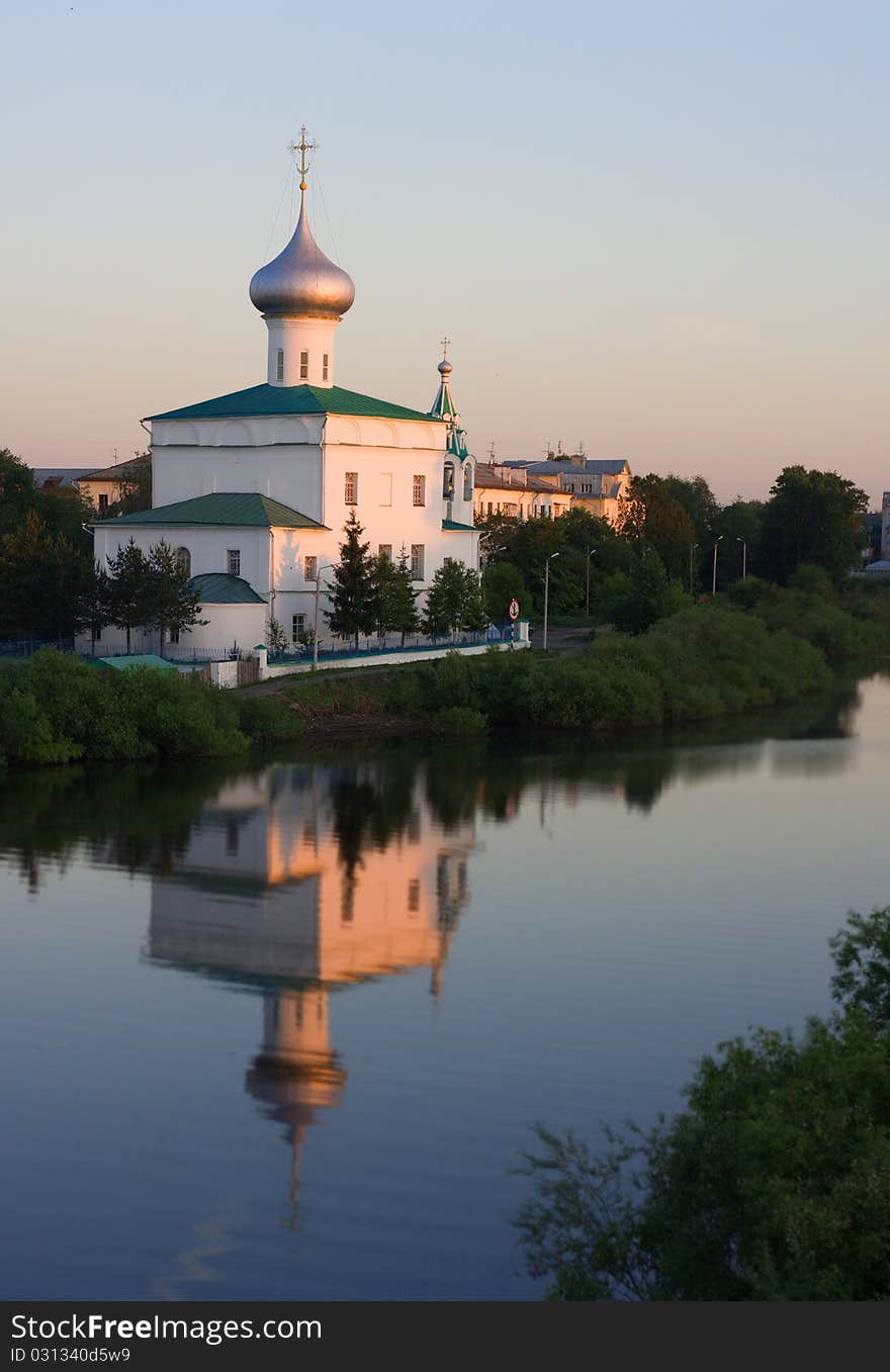 Church of St. Andrew in the setting sun and reflection in the water