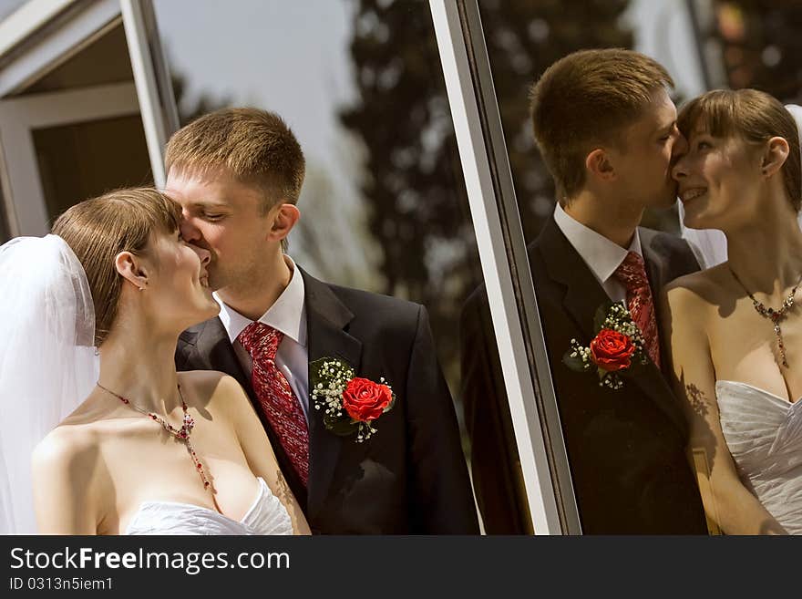 Bride and groom by the mirror outdoor