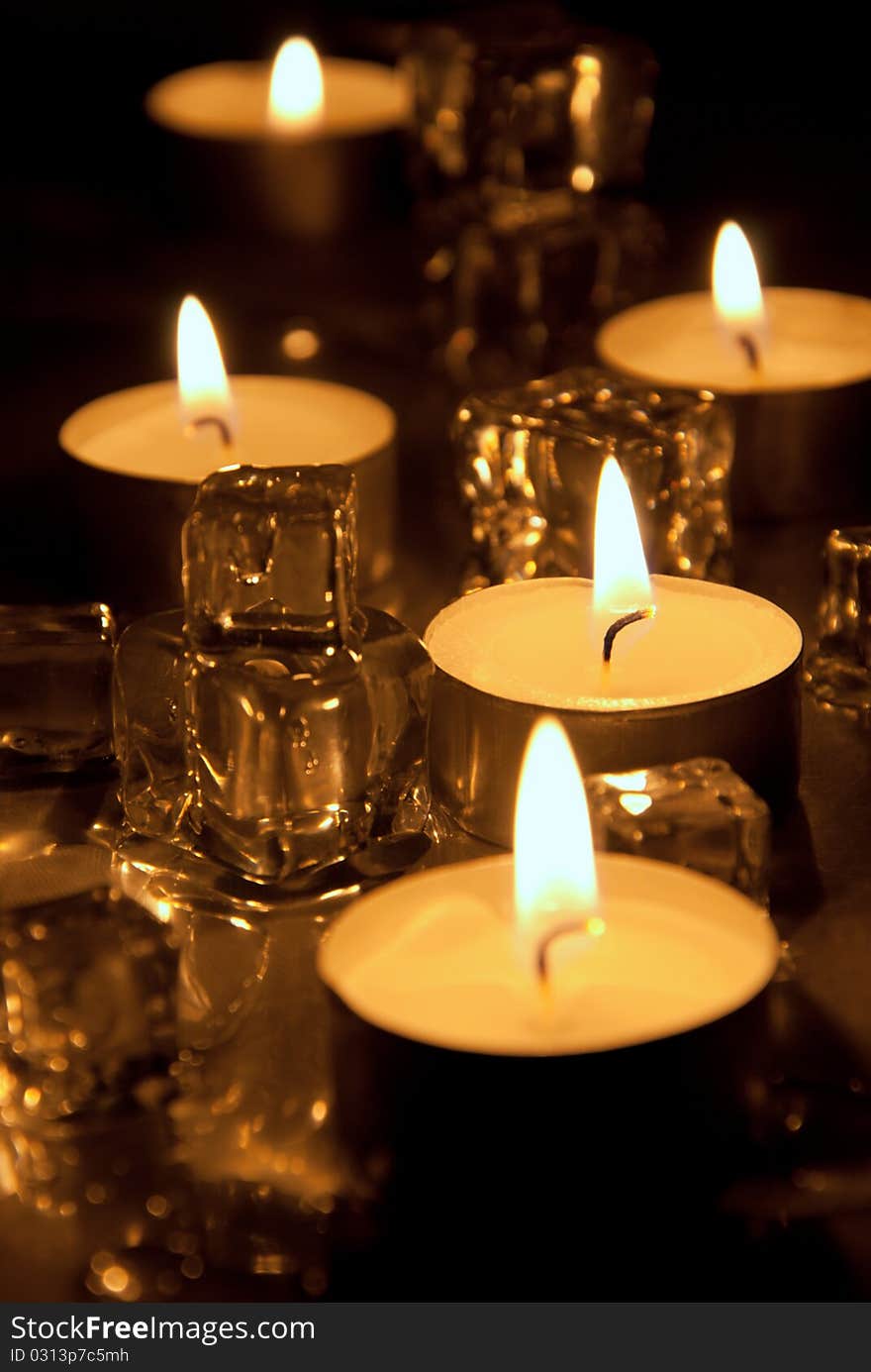 Candles with melting ice cubes and water drops. Candles with melting ice cubes and water drops