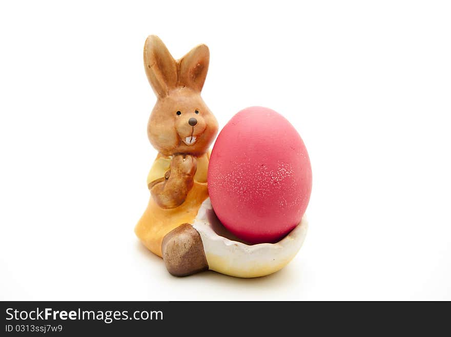 Ceramics Easter bunny with red egg. Ceramics Easter bunny with red egg