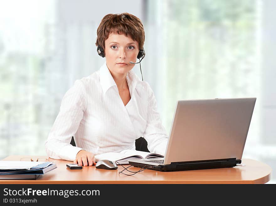 Beautiful businesswoman working with laptop at her office