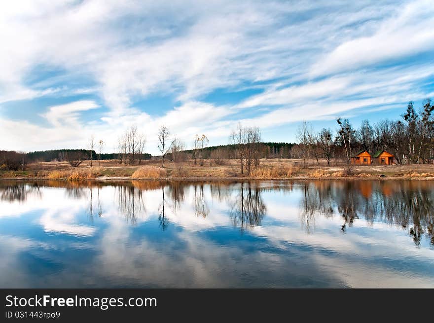 In pure lake the sky and trees are reflected. In pure lake the sky and trees are reflected