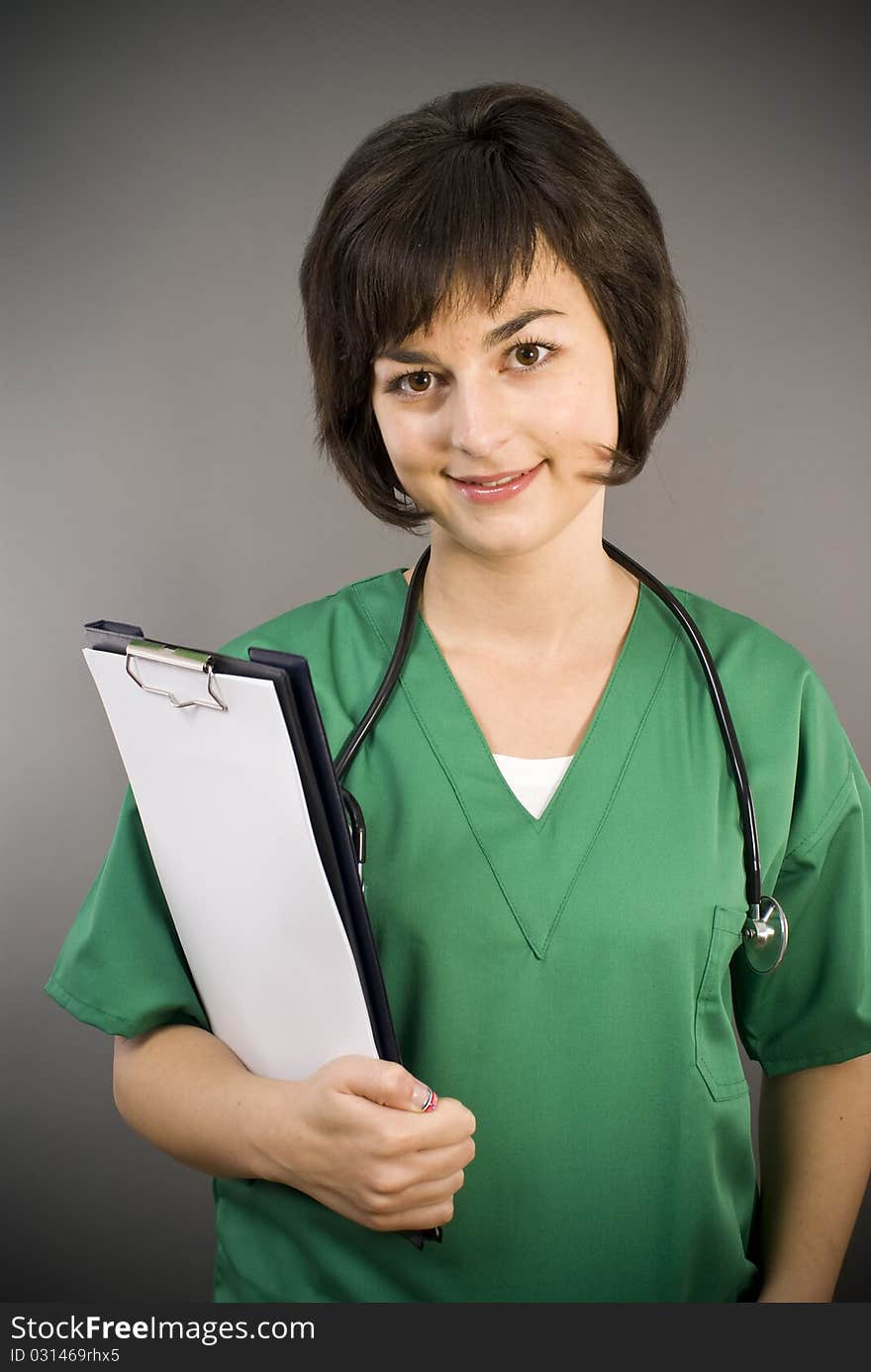 Attractive lady doctor on gray background