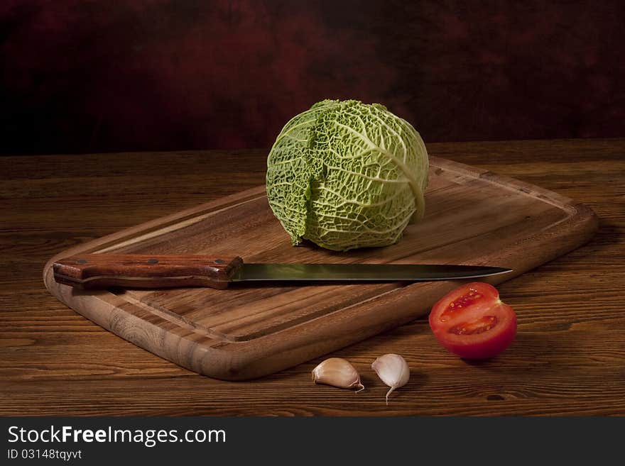 Green cabbage on wooden tablet