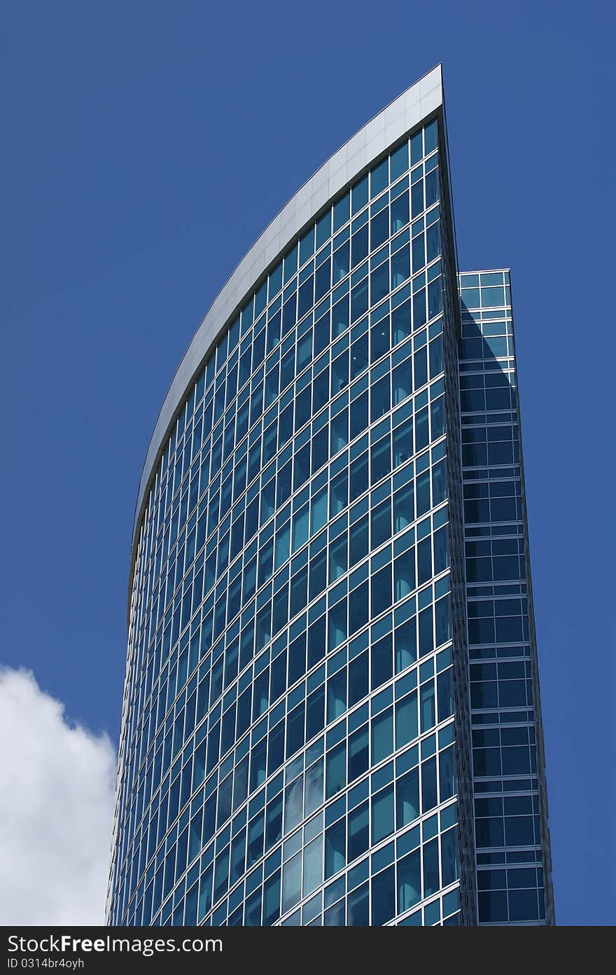 Reflection of a cloudy sky in glass wall