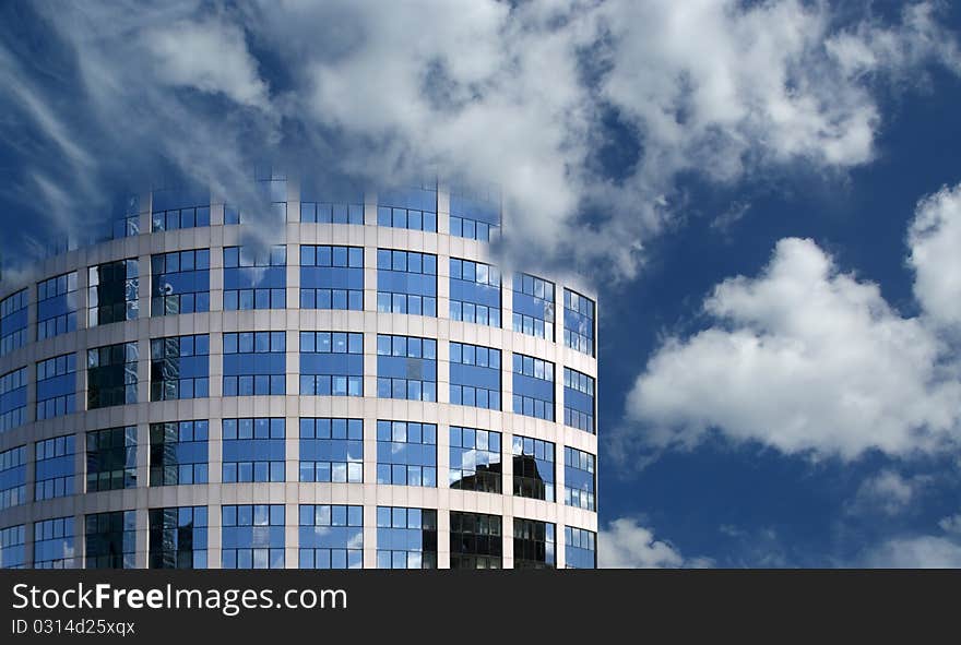 Reflection of a cloudy sky in glass wall