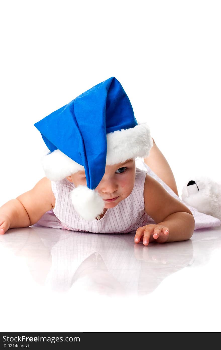 Baby lying in Santa s blue hat