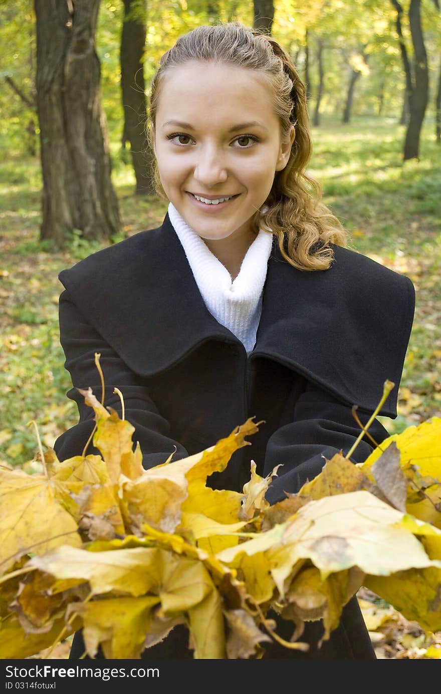 Young Girl With A Bunch Of Gold Leaves