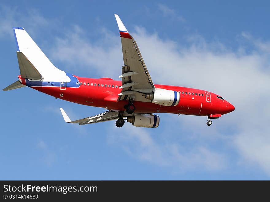 Blue, red and white passenger jet. Blue, red and white passenger jet.