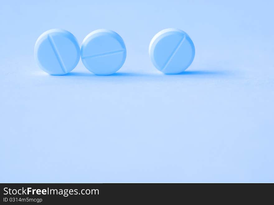 Three Tablets On A Blue Background