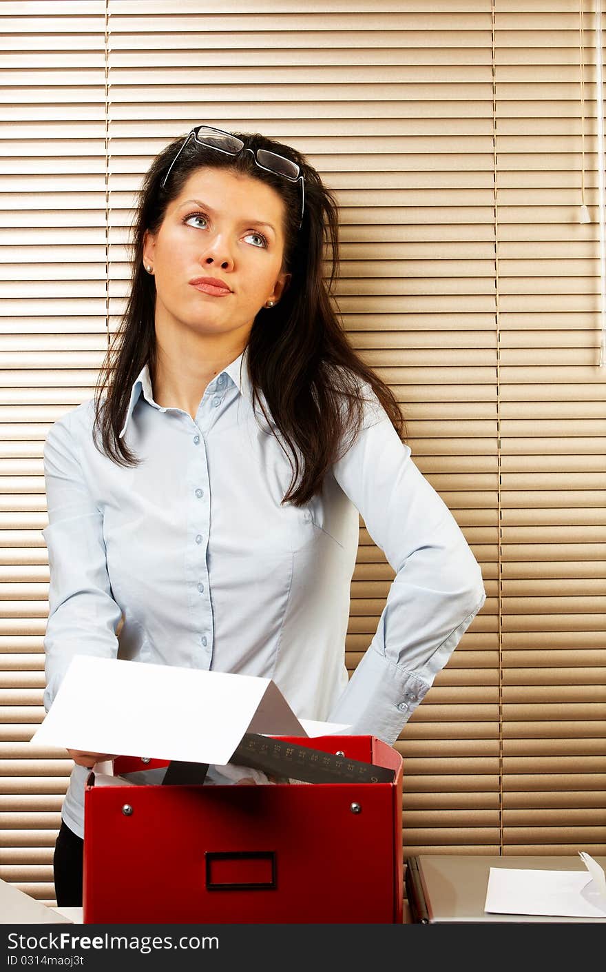 Woman as office worker is reading notice of layoff