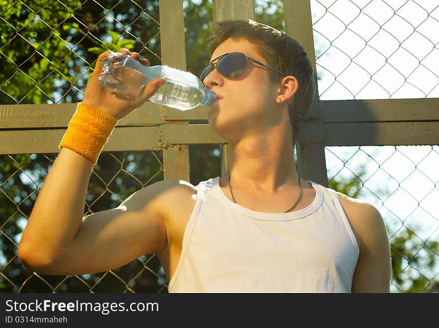 Man is drinking fresh mineral water after sport. Man is drinking fresh mineral water after sport