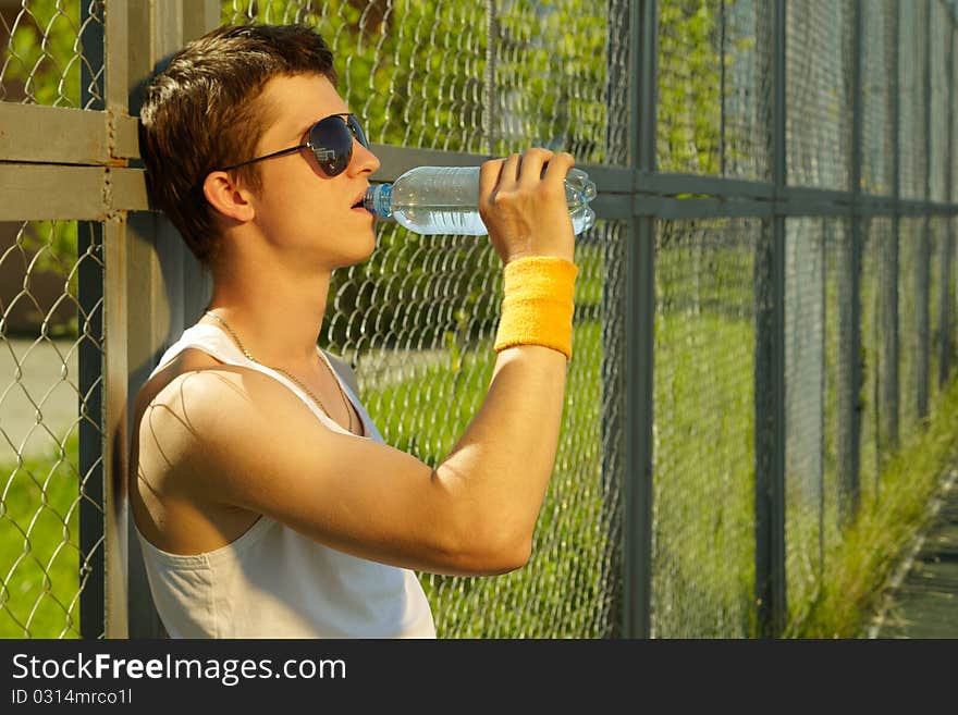 Man is drinking fresh mineral water after sport. Man is drinking fresh mineral water after sport