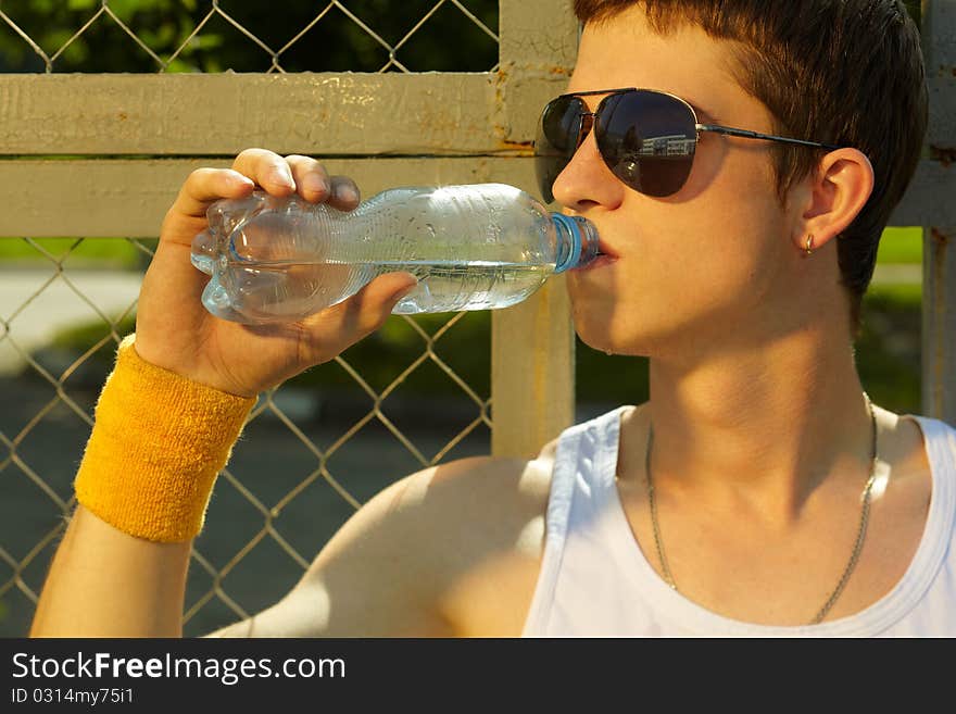 Man is drinking fresh mineral water after sport. Man is drinking fresh mineral water after sport