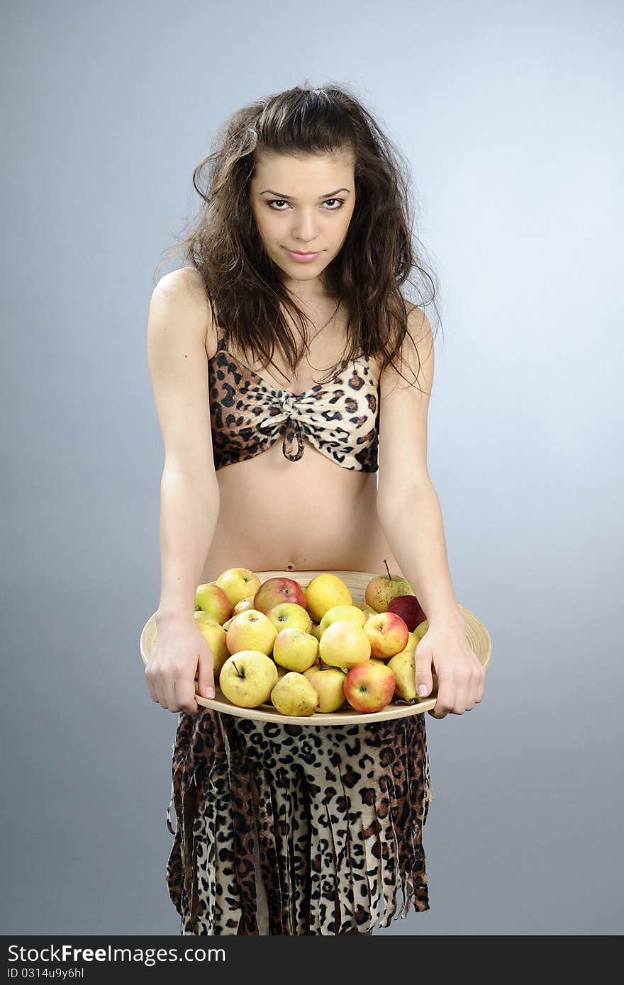 Girl carrying plate with organic apples and pears. Girl carrying plate with organic apples and pears