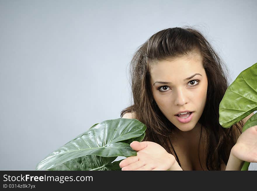 White model simulating hunting with green leaves. White model simulating hunting with green leaves