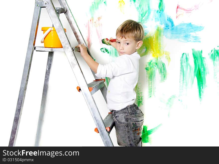 Cute young boy painting over white. Cute young boy painting over white