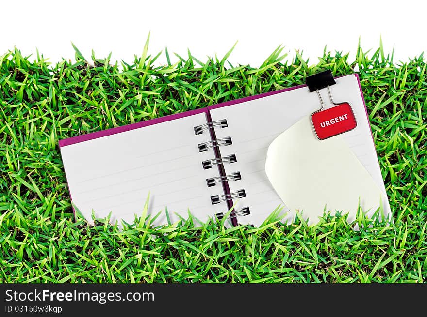 Blank page of note book on grass good to background. Blank page of note book on grass good to background