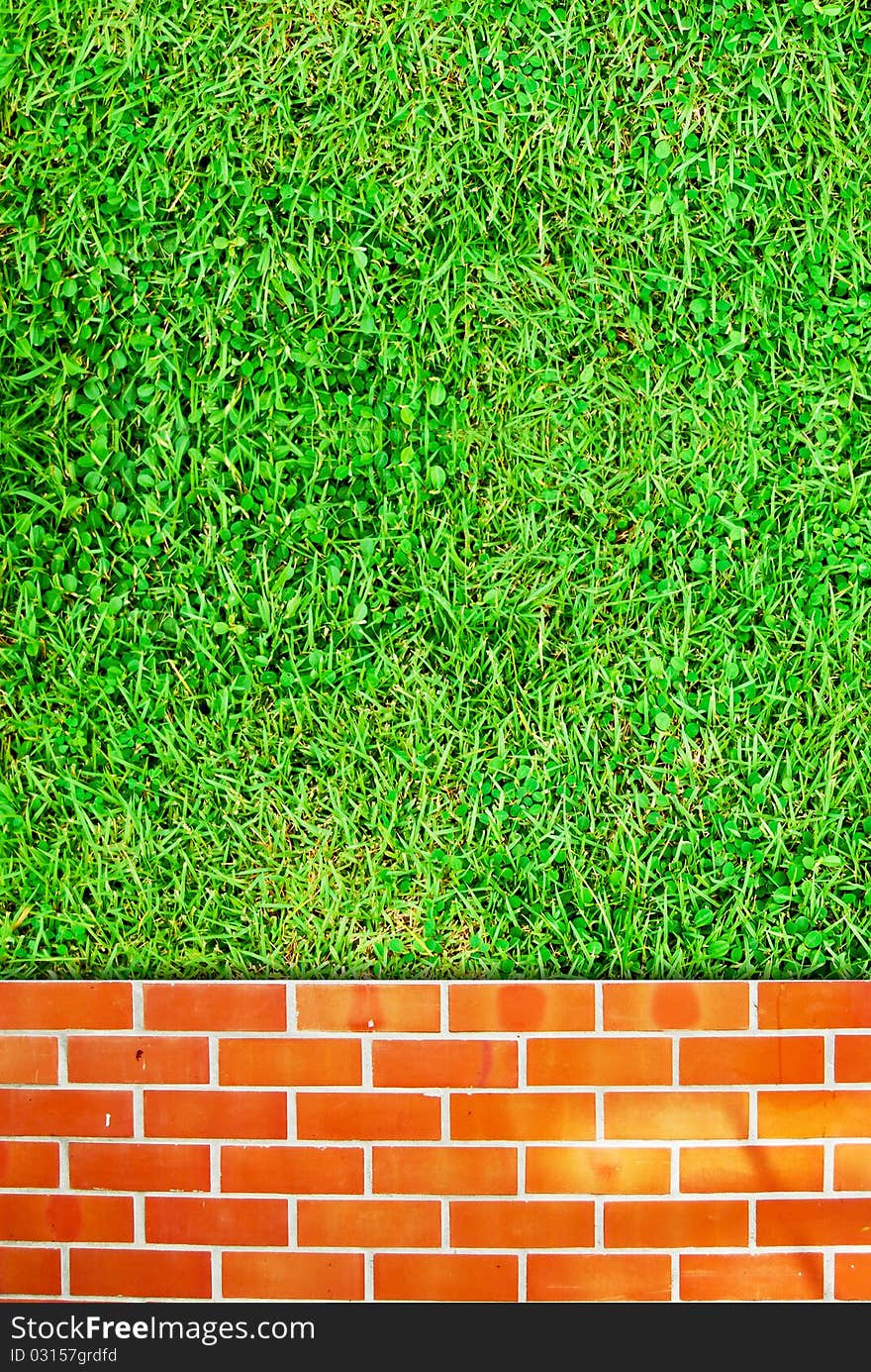 Brick wall fence and grass field background texture