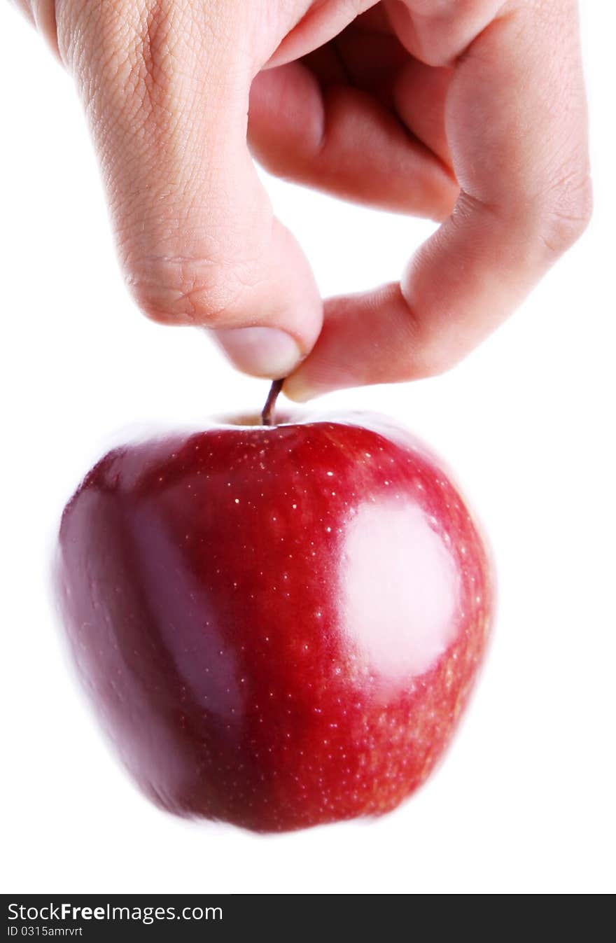 Hand holding a red apple on white background