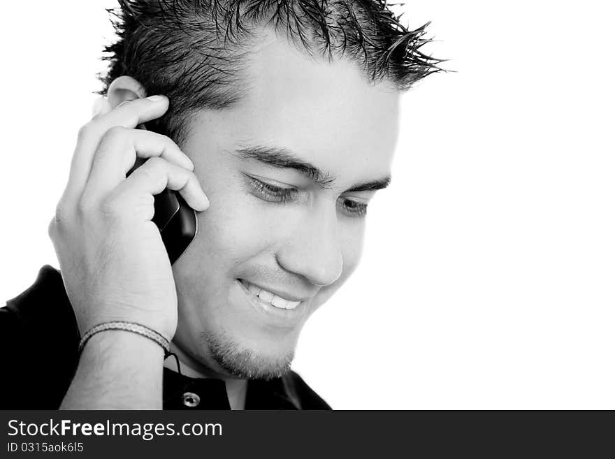 Young man talking on a cell phone on white background, black and white image. Young man talking on a cell phone on white background, black and white image