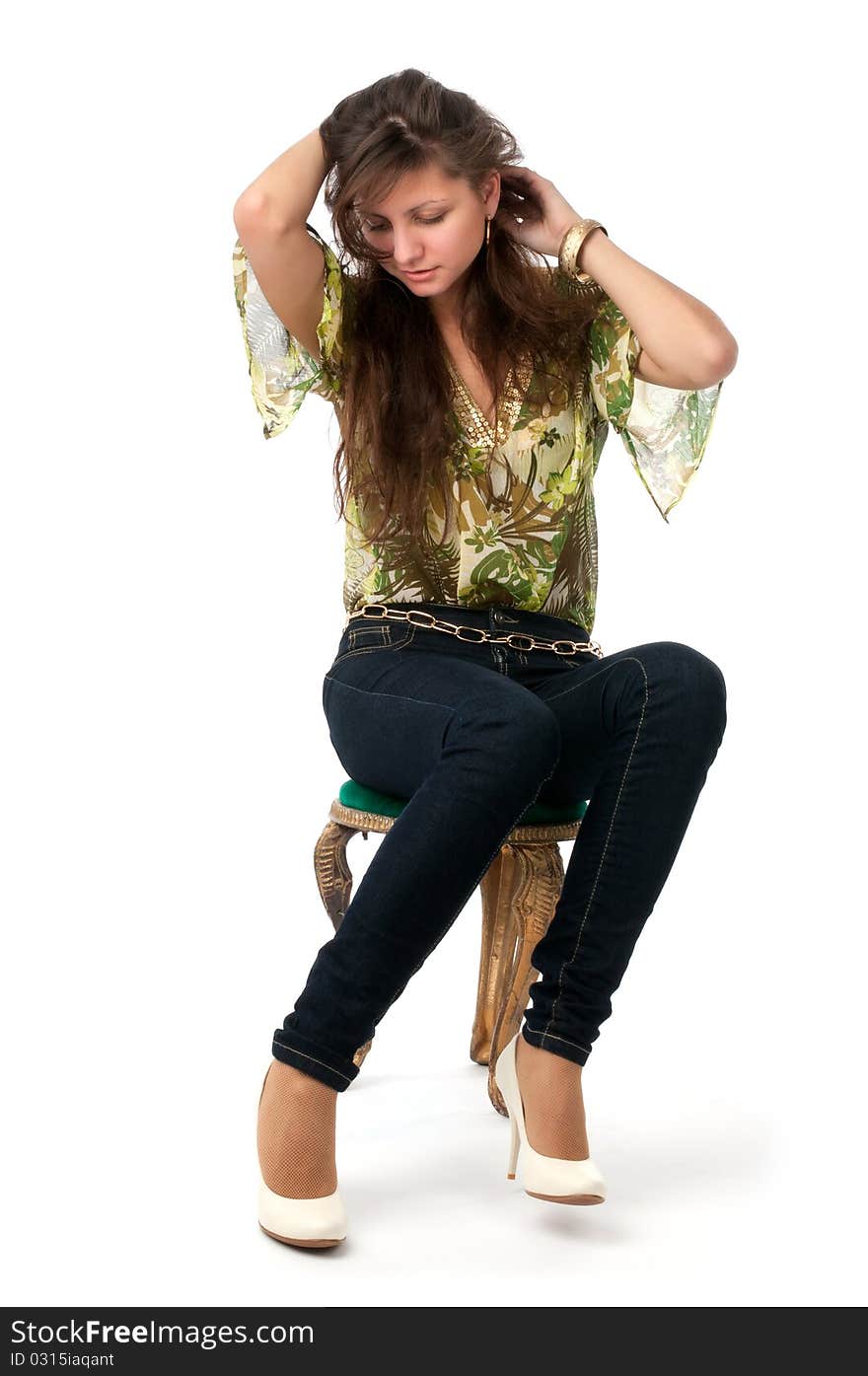 Attractive girl with long hair sitting on the chair. Attractive girl with long hair sitting on the chair