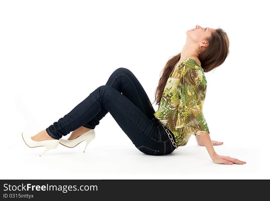 Beautiful young woman sitting on the floor