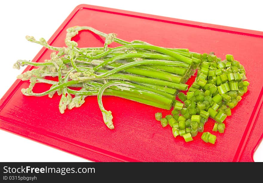 The image of runaways of an edible fern on a kitchen board. The image of runaways of an edible fern on a kitchen board