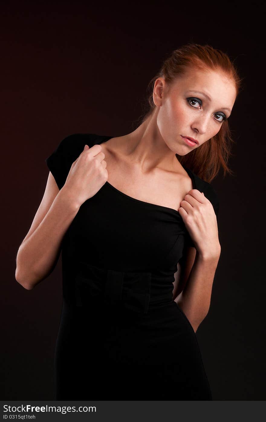 Portrait of a young redhead woman in black dress