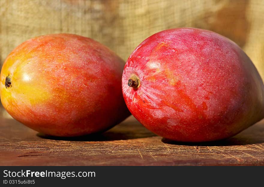 Two red and mature mangoes fruits. Two red and mature mangoes fruits.