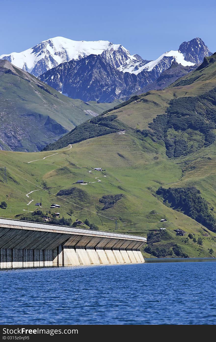 Lake and weir in alpine mountain in France on summer. Lake and weir in alpine mountain in France on summer