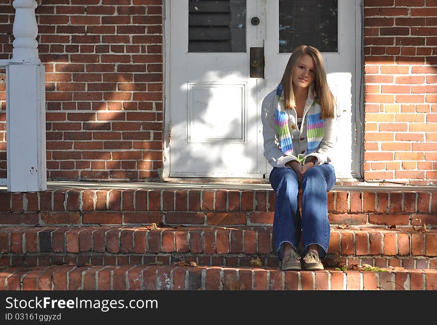 Pretty Teen Girl Sits On Front Steps