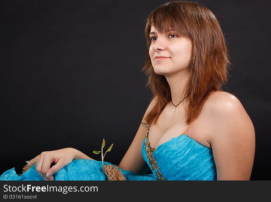 The girl in the long blue dress on the black background.