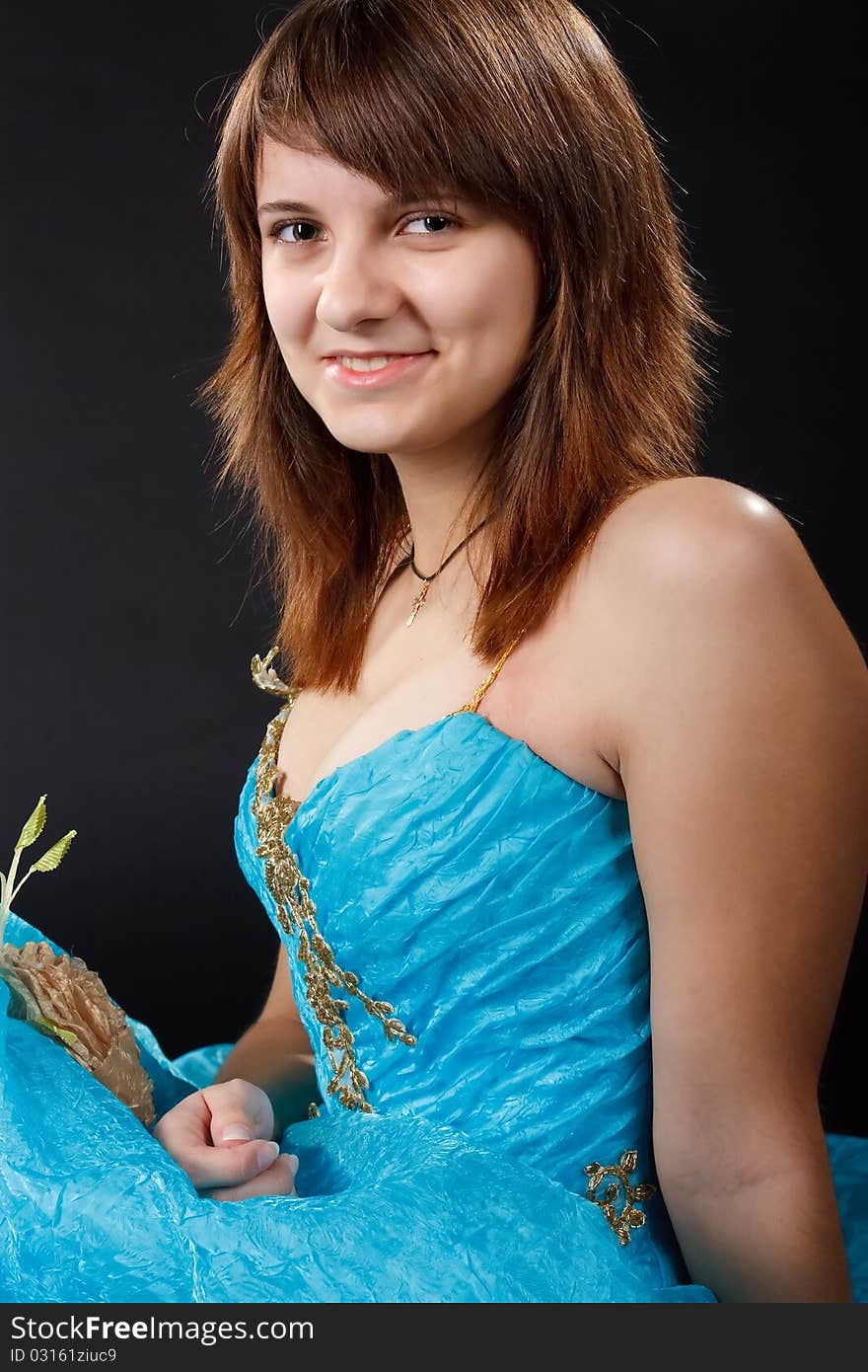 The girl in the long blue dress on the black background.