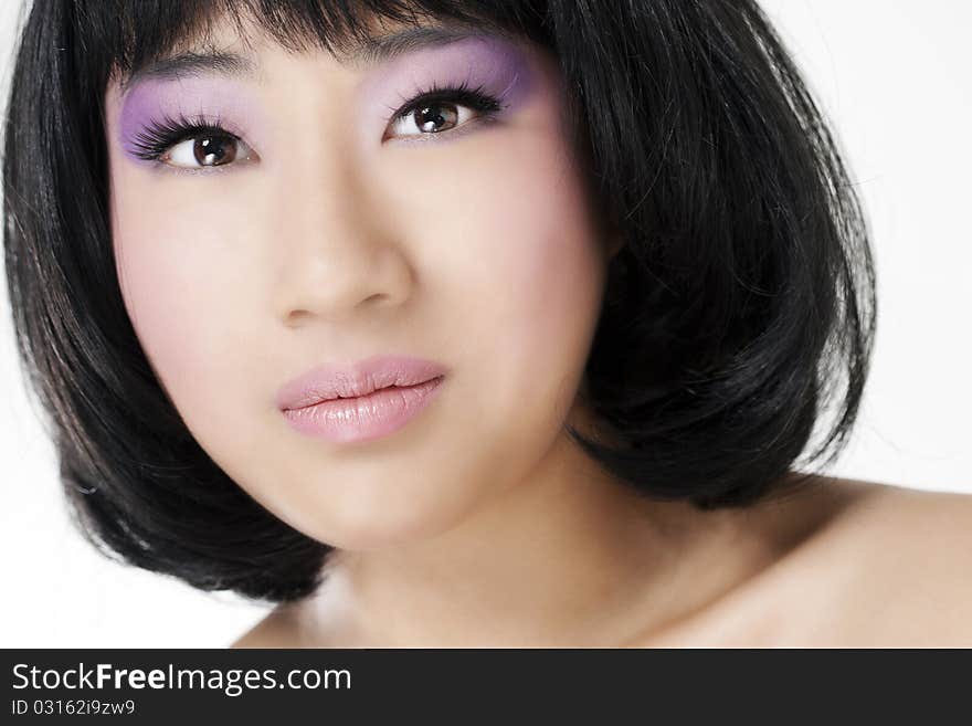 Beautiful asian woman with bright makeup isolated on white background.