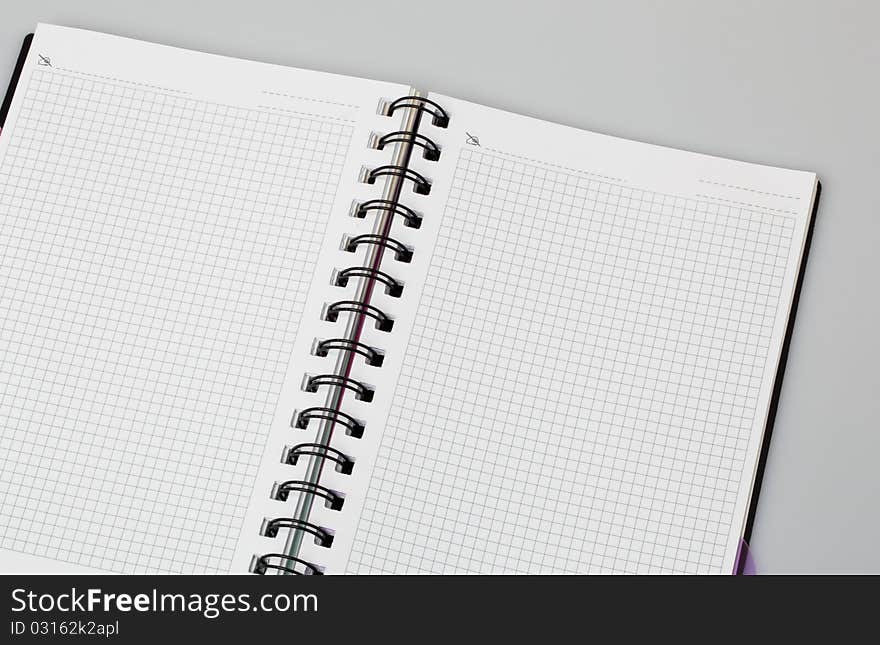 Spiral notebook on grey background